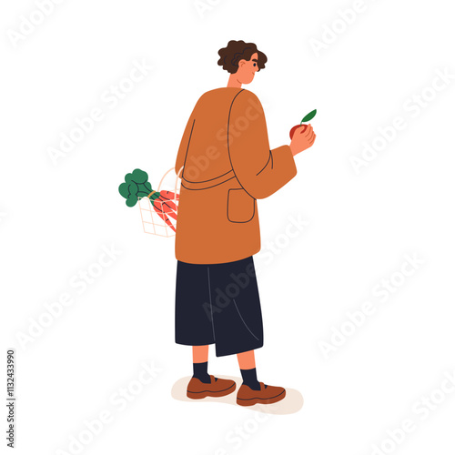 Shopping for fresh fruits and vegetables. Woman holding basket with organic c...