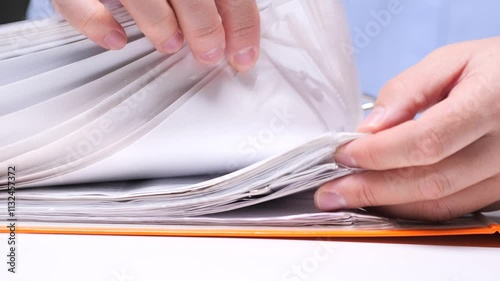 close-up Office worker searches for the necessary document in a folder