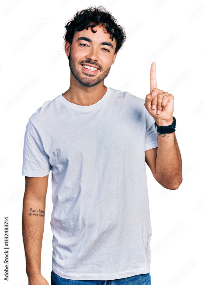 Naklejka premium Hispanic young man with beard wearing casual white t shirt pointing finger up with successful idea. exited and happy. number one.