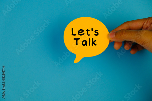 Top view image of speech bubble with text LET'S TALK on blue background with copy space. 