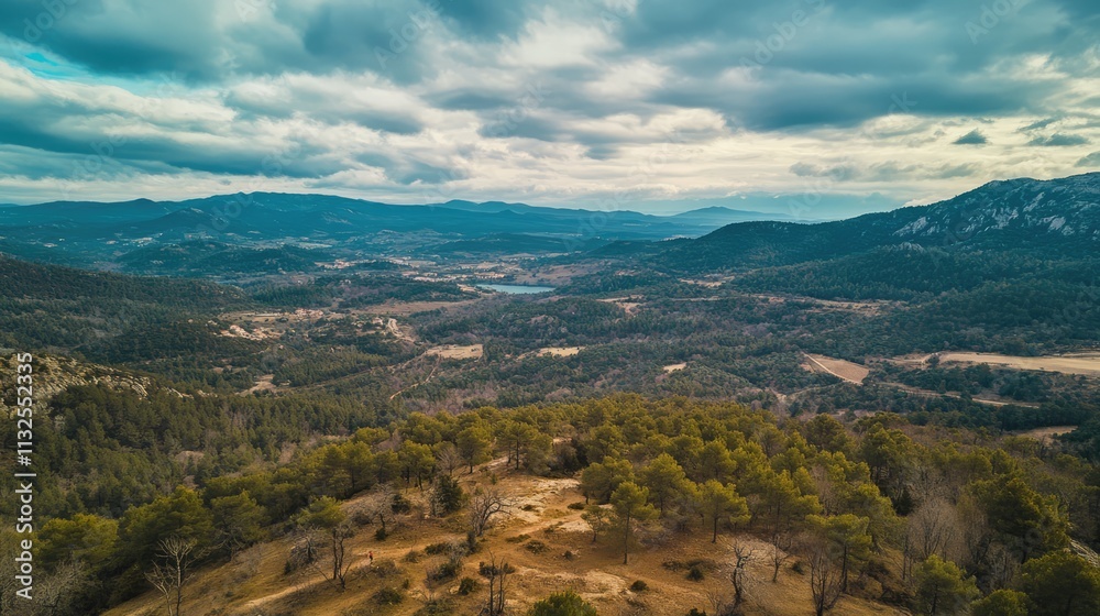 Fototapeta premium Aerial view from a mountain capturing lush valleys and expansive skies under a dramatic cloudscape with a stunning landscape below