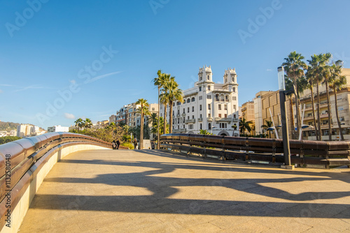 Obraz na płótnie Beautiful street view of Ceuta with Hercules statue shade on the pavement in the foreground, Spain, North Africa w salonie