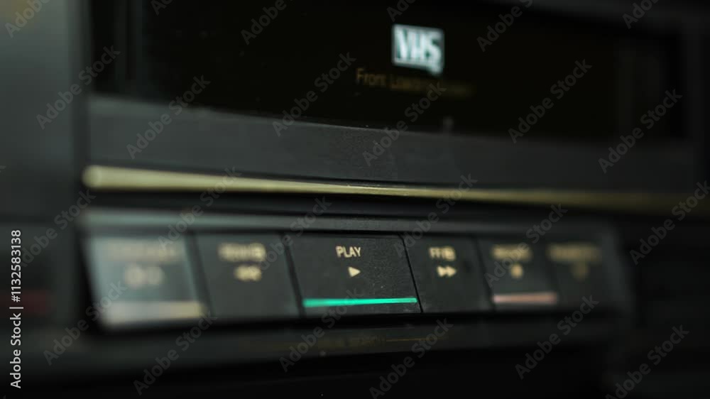 Loading Colored VHS Video Cassette Ta[e and Pressing Play Button on VCR Loading Colored VHS Video Cassette Ta[e and Pressing Play Button on VCR