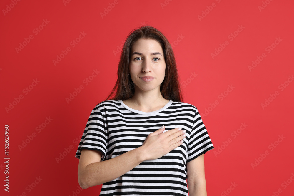 Woman making promise on red background. Oath gesture Woman making promise on red background. Oath gesture