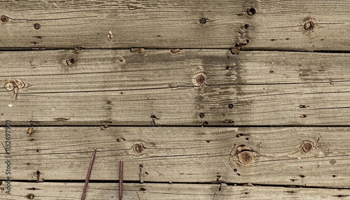 A rustic wooden wall displays weathered planks with multiple nail holes, cracks, and rough textures, reflecting aged and natural character. AI generated. photo