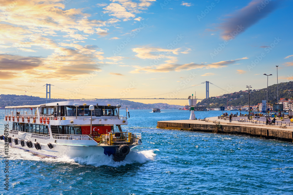 Ship is sailing near the Bosphorus bridge, sunset view, Istanbul, Turkey