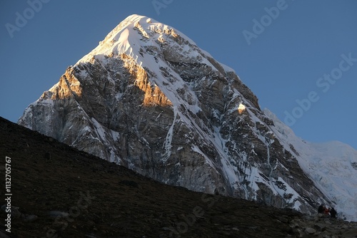 Amazing sunset scenery with Mount Pumori lit by sun. View from Kala Patthar viewpoint. Everest Base Camp, Sagarmatha National Park, Khumbu valley, Nepal, Himalayas photo