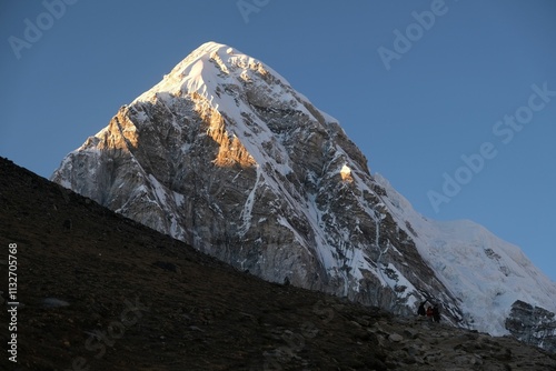 Amazing sunset scenery with Mount Pumori lit by sun. View from Kala Patthar viewpoint. Everest Base Camp, Sagarmatha National Park, Khumbu valley, Nepal, Himalayas photo