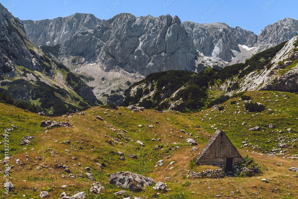 Abandoned Wooden Hut in Alpine Mountain Landscape