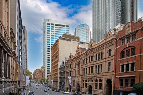 Historic Burns Philp building and modern skyscrapers in the Sydney CBD under a blue sky