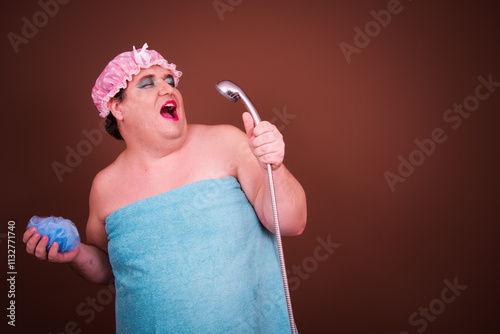 Drag queen. A funny fat man washes in the shower in a pink cap. photo