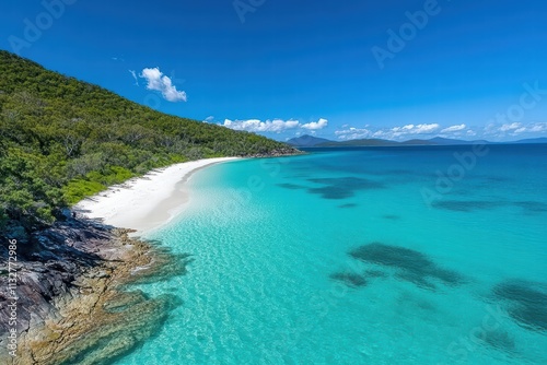 Serene Tropical Beach with Crystal Clear Water and Lush Green Hills photo