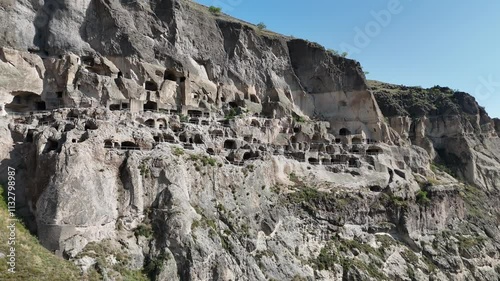 Aerial view of Vardzia cave monastery on Kura River bank in Georgia, ancient city complex carved into Erusheti rocky mountain. UNESCO World Heritage tentative list.