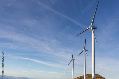 Wallpaper Mural Wind turbines generating green energy on mountain top under blue sky Torontodigital.ca
