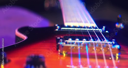 Close-Up of an Electric Guitar. Details of strings, frets, and the body shine under moody lighting. Music, creativity, and rock culture.