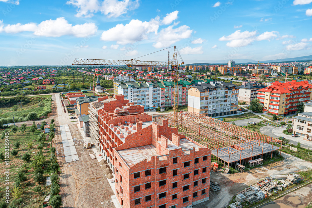 Construction of a multi-story brick building in a small town.
