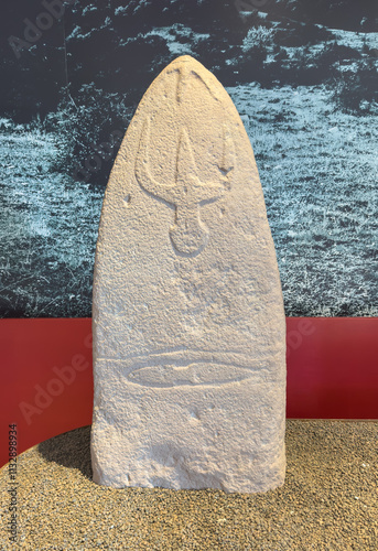 Neolithic stone stele depicting a carved trident, discovered in Laconi, Sardinia photo