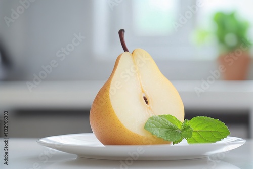 photo of a sliced pear on a white ceramic plate with a sprig of mint, blurred kitchen background, close-up composition, soft diffuse lighting