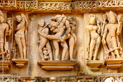 India. Madhya Pradesh state. The Khajuraho Group of Monuments are a group of Hindu and Jain temples. Erotic sculpure at Lakshmana temple photo