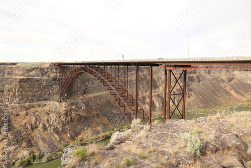 Rusted steel bridge crossing deep canyon