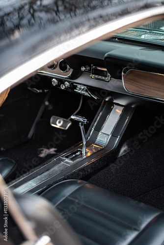 Interior Of A Classic Vintage Car with Wooden Dashboard and Chrome Details