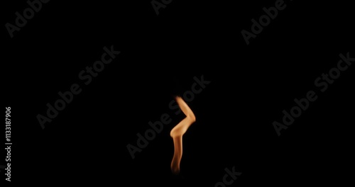 Small Blurry Orange Flame on Black Background photo