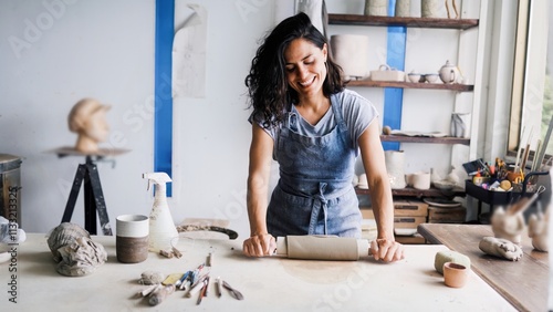 Art business, Artist work with ceramic at clay pottery workshop studio. Latin woman knead dough. Handmade creativity concept