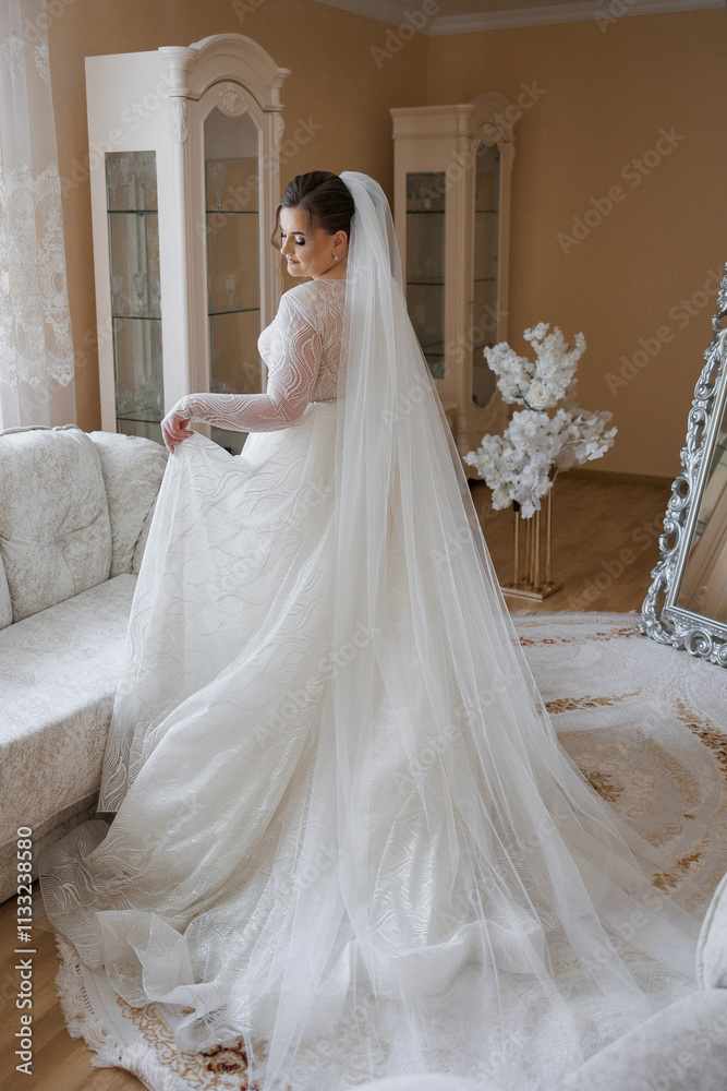Fototapeta premium A bride and groom are sitting on a set of stairs, with the bride holding a bouquet. Scene is romantic and happy, as the couple is celebrating their wedding