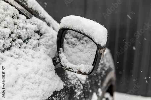 A car swept by snow. Snow on the rearview mirror photo