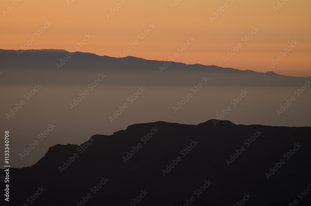 Fototapeta premium Silhouette of the east of the island of Tenerife from Gran Canaria at sunset. Canary Islands. Spain.