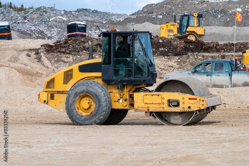 Compaction of sand in an embankment with a compactor roller
