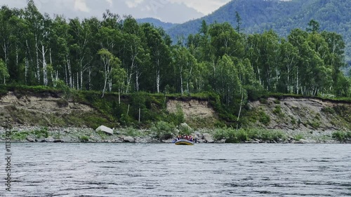 A group of people rafting on a mountain river.