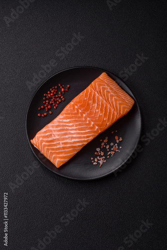 Fototapeta Naklejka Na Ścianę i Meble -  Fresh raw salmon steak with spices and herbs