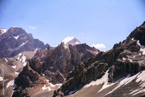 mountain landscape on a sunny day. Gray rocks and mountains covered with snow without vegetation photo