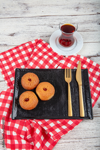 Sekerpare dessert. Ramadan dessert. Sekerpare dessert with syrup and Turkish tea on a serving plate. photo