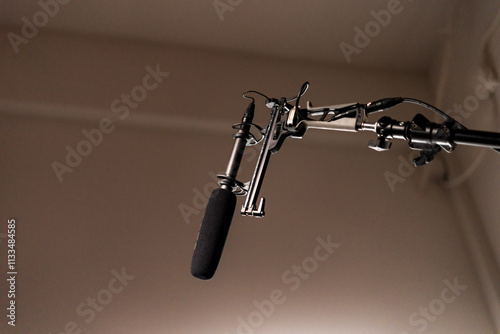 Boom Microphone for sound recording in film industry. Boom mic holds up high by video or film production