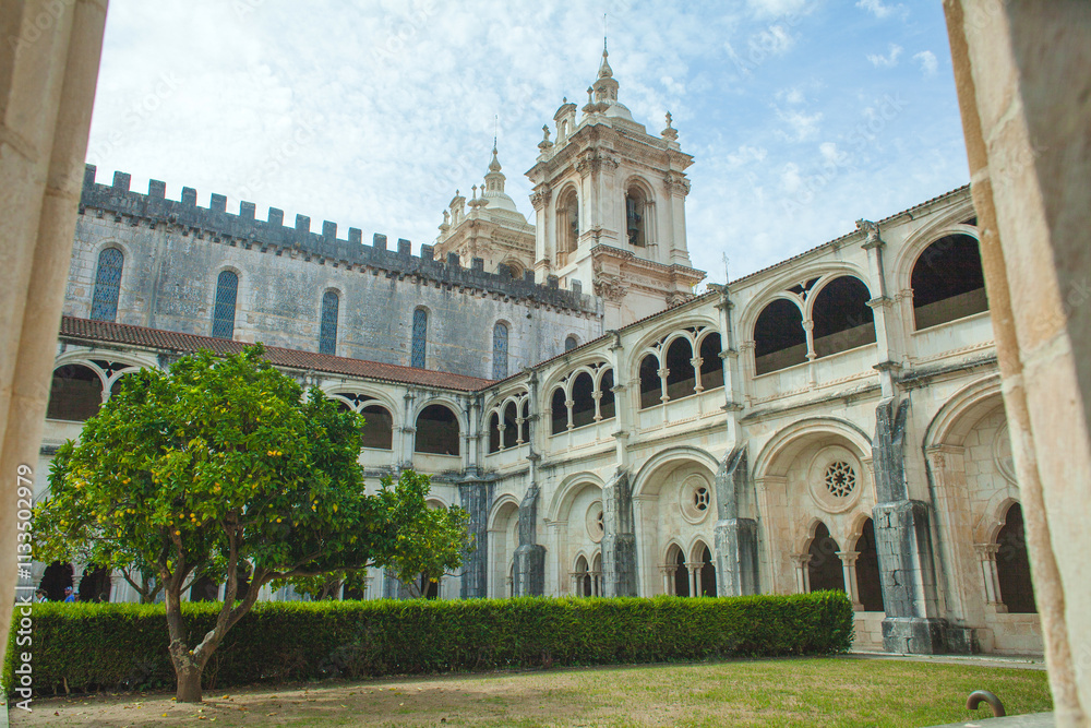 Obraz premium A picturesque view through an arched doorway of a historic monastery