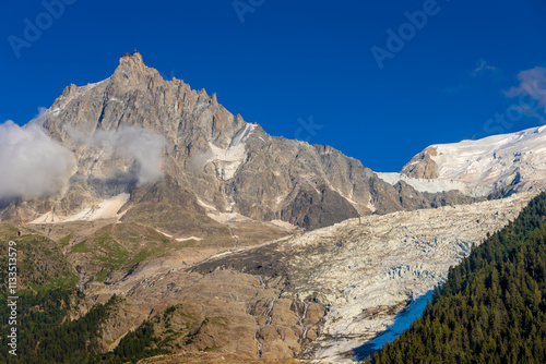 Aiguille du Midi peak in the Alps. Chamonix valley landscape of a prominent rocky towering mountain peak in french Alps. Chamonix-Montblanc area beautiful landscape of Aiguille du Midi summit