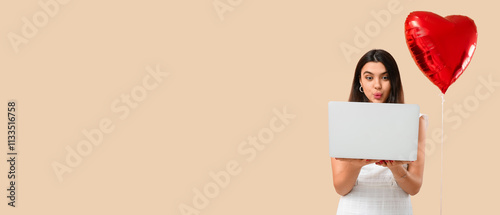 Young woman with laptop and...