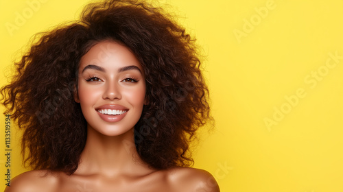 A confident Latina woman straightens her silky brown hair, her radiant smile set against a simple pastel yellow background. photo