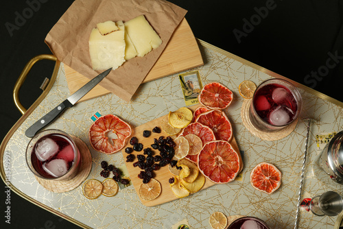 Mesa vintage con coctelería, frutos secos y queso.