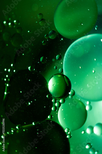 Wallpaper Mural Green bubbles floating in liquid create an abstract visual in a dark setting Torontodigital.ca