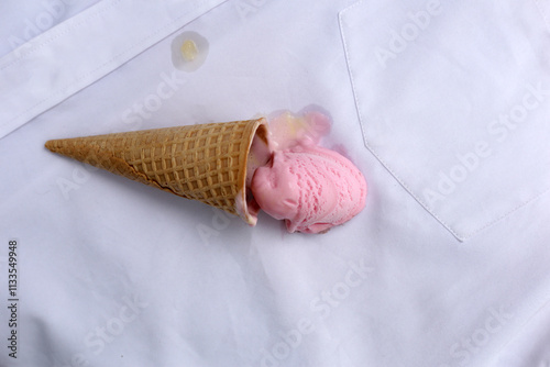 Iice cream with waffle cone on a white shirt, dirty stain photo