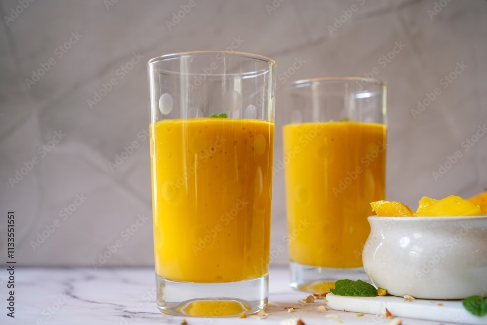 Fototapeta premium Homemade Mango Lassi | Traditional Indian smoothie with mangoes, selective focus
