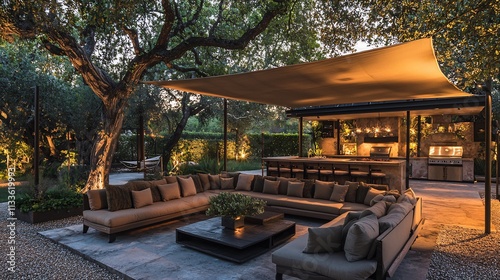 Elegant outdoor lounge a sectional sofa coffee table and a large shade sail set under trees with ambient lighting