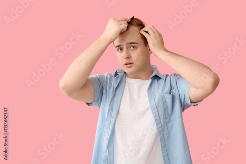 Young redhead man with hair...
