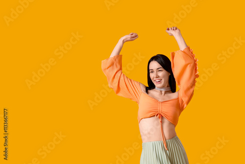 Happy young woman dancing o...