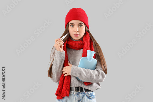 Ill young woman with thermo...