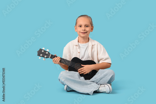 Little girl playing guitar ...