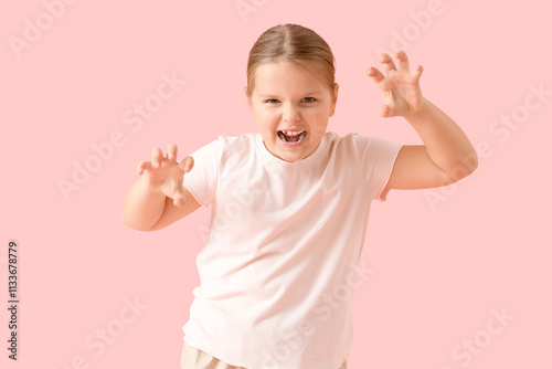 Portrait of aggressive little girl on pink background